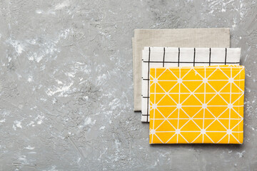 top view with yellow empty kitchen napkin isolated on table background. Folded cloth for mockup...