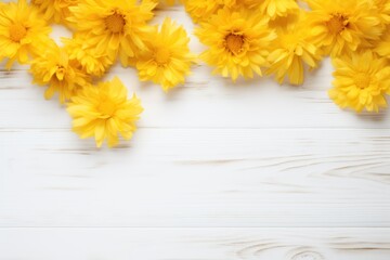 Beautiful yellow cornflower flowers on a white wooden background, in a top view with copy space for text