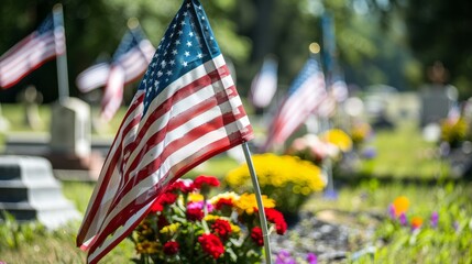 Close-up of an American flag in a cemetery with floral decorations.
