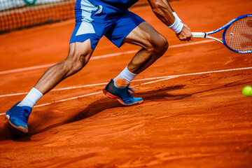 Motion blur of tennis player in action on clay court