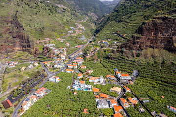 Aerial view of small farming village with banana plantation at Madeira Atlantic Ocean coast - 785093887