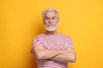Senior man with mustache on orange background