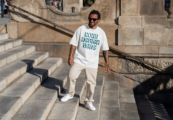 Mockup of man wearing customizable t-shirt on steps