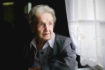 Portrait of an elderly woman in a stylish suit with an intricate woven pattern. - 785096066