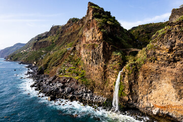 Waterfall fall into Atlantic Ocean in Madeira Island, Portugal. Aerial Drone view - 785096879