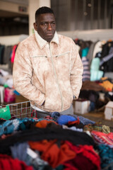 Afro-American guy sells sacond hands clothes on flea market