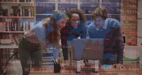 Image of stock market data processing over three diverse colleagues discussing over laptop