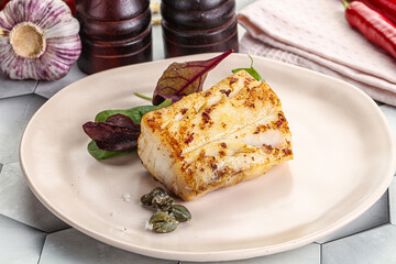 Roasted cod fish steak with salad