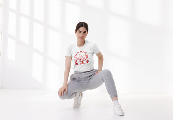 Mockup of woman wearing customized t-shirt, crouching - obrazy, fototapety, plakaty