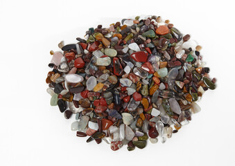 Heap of natural semiprecious stones isolated on white background. Texture of colorful gems