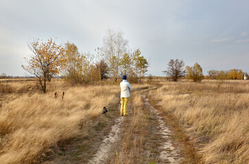 Owner walking with a dog on nature. Friendship of a dog and a woman