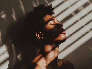 Man Enjoying Sunlight at Home with Eyes Closed - Minimalistic Setting with Hard Shadows