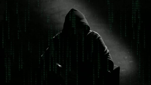 Anonymous man in a hood interview video footage. Mysterious man sitting on a chair and talking. Anonymous hacker interview with no visible face, computer hacker conceptual background