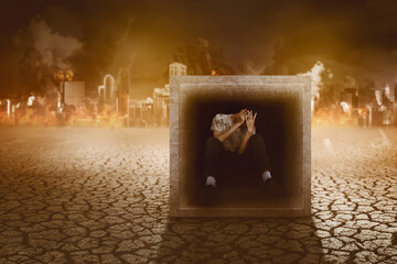 Scared man trapped in a box surrounded by fire