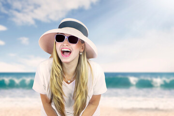 Happy beautiful young caucasian woman wearing sunglasses and hat