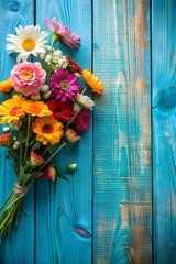 Vibrant bouquet on blue wood, copy space