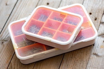Two plastic boxes with nails, screws and bolts