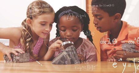 Digital composite of 2 girls and a boy holding a magnifying glass and observing rocks