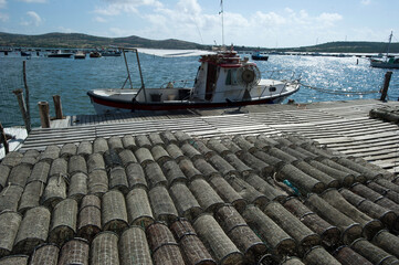 fishing boats and fishing traps in the port at Marceddì, Oristano, Sardinia, Italy