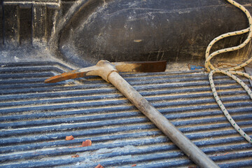 worker pickaxe and rope in the back of a pickup truck. selective focus . High quality photo