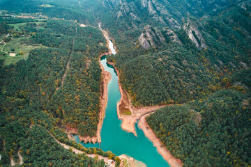 Scenic aerial view of a river winding through trees and mountains