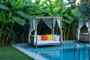 Relaxation Area Inside the Pool Surrounded by Tropical Trees Photo, Alacati Cesme, Izmir Turkiye (Turkey)