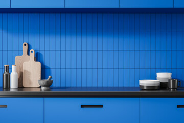 Blue home kitchen interior with kitchenware on counter and dishes