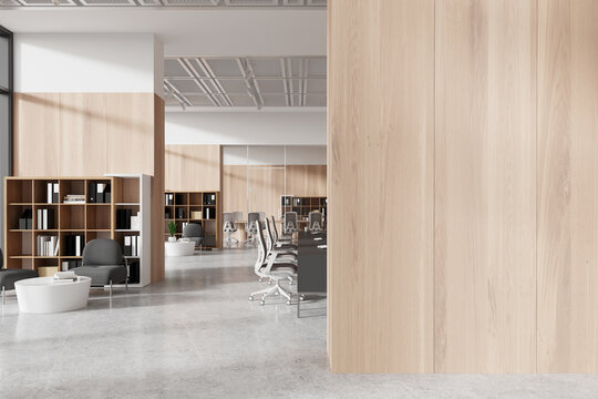 Modern office interior visible behind a blank wooden wall, ideal for a mockup on a light background, showcasing workspace concept. 3D Rendering
