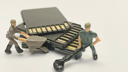 Miniature workers transferring memory cards