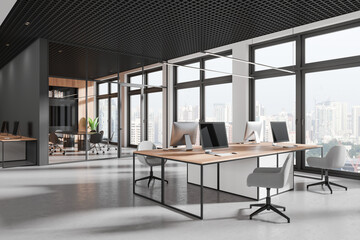 Stylish office interior with glass meeting room and coworking zone, window