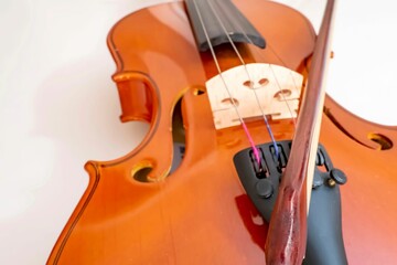 Closeup shot of a violin and bow on white background