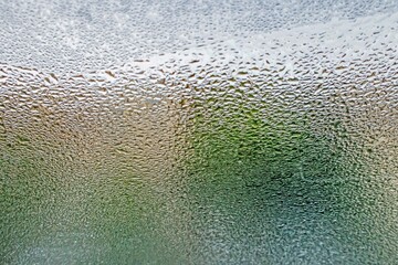 Close up shot of  raindrops on the glass of the window, perfect for background