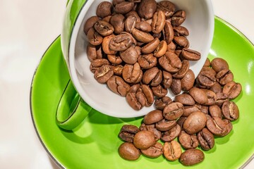 Cup of roasted coffee beans on the table