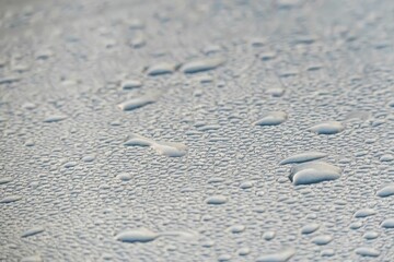 Fototapeta na wymiar Close-up shot of raindrops and droplets on the glass