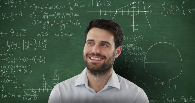 Image of smiling Caucasian man looking up in front of chalkboard with moving mathematical graphs and
