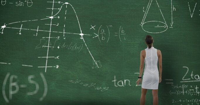 Image of a young Caucasian woman seen from behind standing and looking at chalkboard with moving mat
