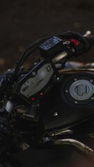 Vertical closeup shot of the steering wheel of a motorbike