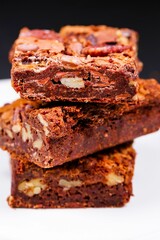 Vertical closeup of brownies on top of each other.
