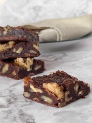 Chocolate brownies with nuts isolated on white background