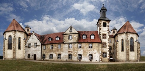 Panoramic view of hotel Kloster Haydau against a cloudy blue sky in Germany