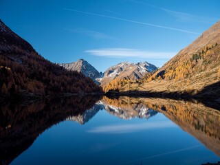 Beautiful shot of lake Landschitzsee reflecting trees and mountains in Salzburg, Austria