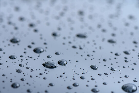 raindrops on glass window of car with cloudy sky in the background 4