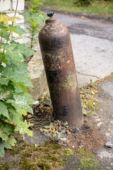 Vertical shot of the old carbon dioxide bottle in the street