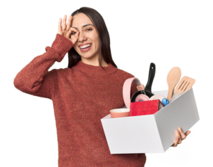 Caucasian young woman holding a box for moving on studio background excited keeping ok gesture on eye.