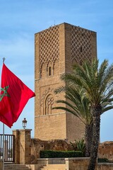 Moroccan flags fluttering and the Hassan tower in the background in Rabat