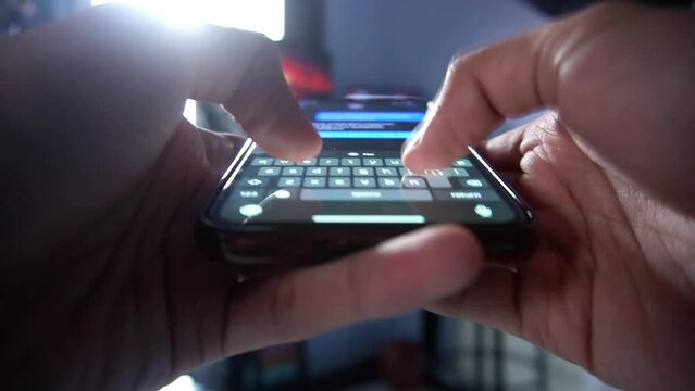 Man's hand using mobile phone texting or chatting. close up typing a message on a smartphone