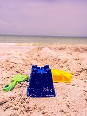 Selective focus shot of sand toys on a beach in Florida