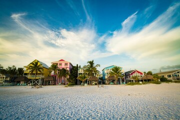 Houses near a beach against a cloudy sky in Estero Island, Florida