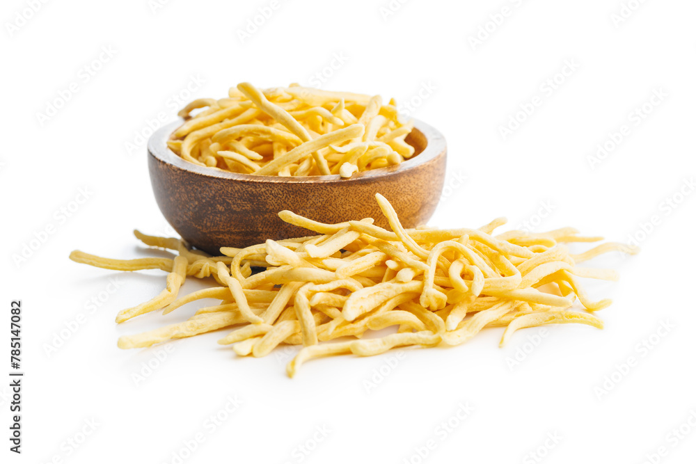 Wall mural uncooked spaetzle pasta in bowl isolated on white background.