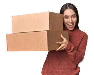 Young Caucasian woman holding moving boxes